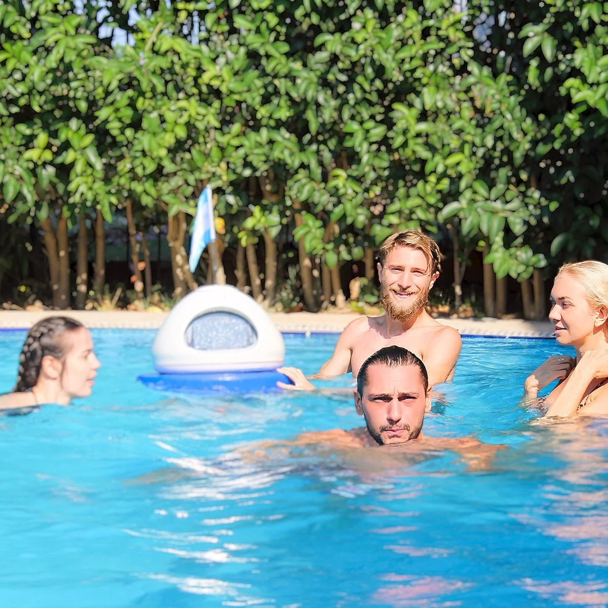 Aquabooth, the world's first underwater photo booth, floating in a pool