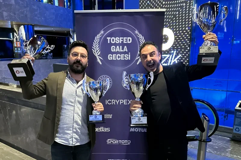 Atilla Baybara and co-pilot Cuneyt Gokturk holding championship trophies at the TOSFED Gala